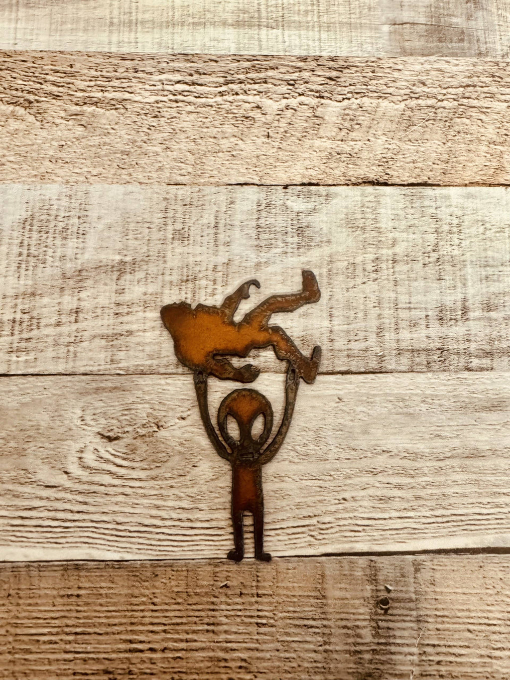 Alien Holding Bigfoot Rustic Metal Magnet