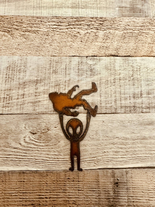 Alien Holding Bigfoot Rustic Metal Magnet